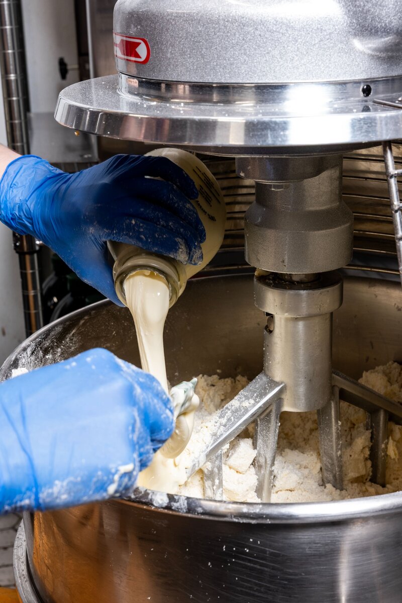 Gluten-free dough being mixed by hand and machine at Grain Artisan Bakery, symbolizing craftsmanship, quality, and local ingredients.