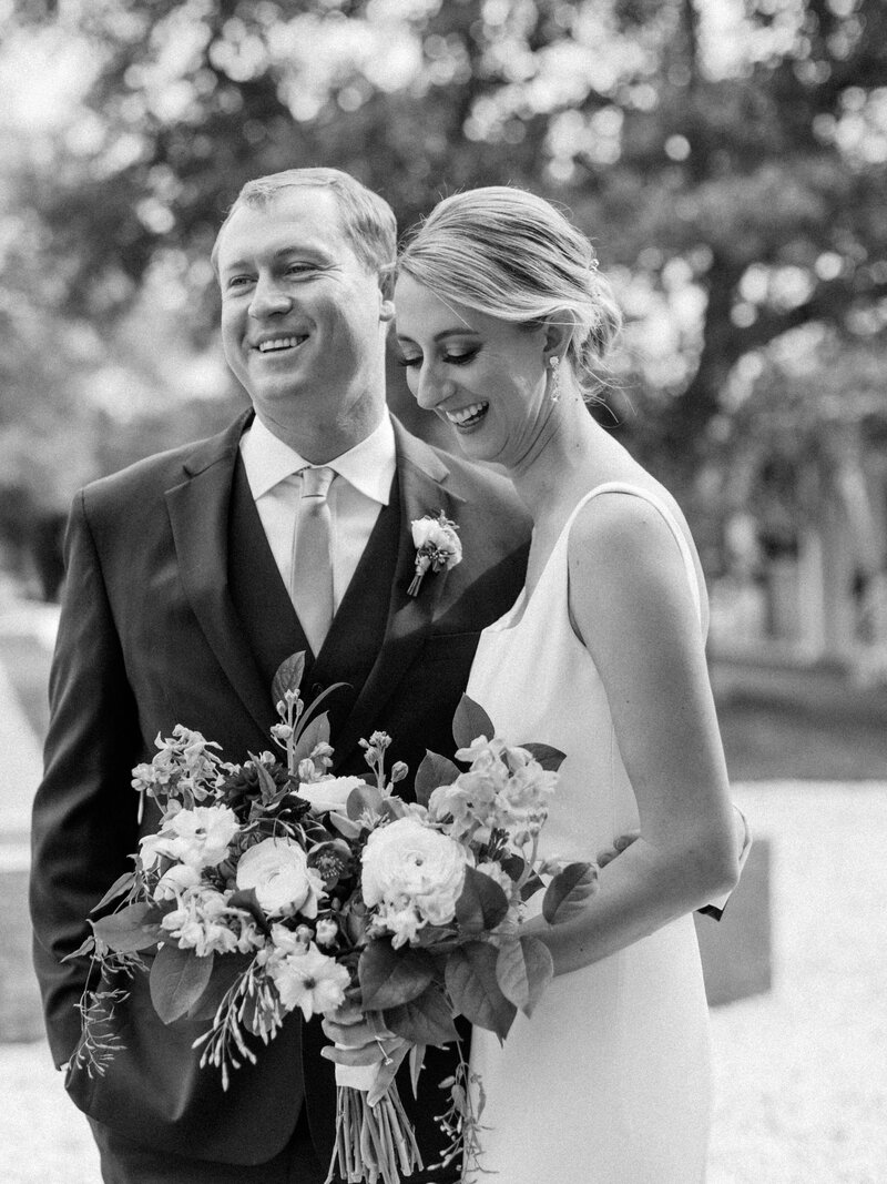 Bride and groom smile at camera