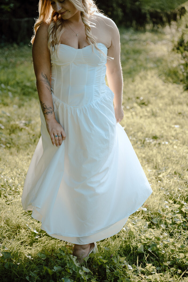 Girl in white dress walking in grass