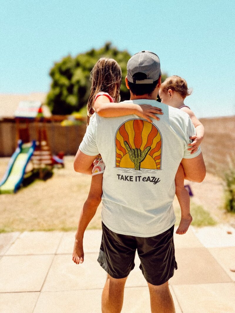 dad holding kids wearing AZ shirt