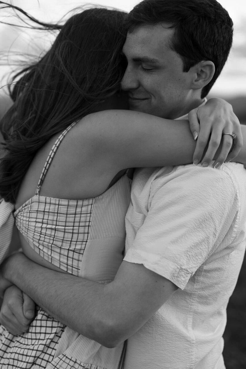 Man and woman hugging on top of Max Patch in Hot Springs NC on the Blue Ridge Parkway, documented by Andrea-Marie Photography