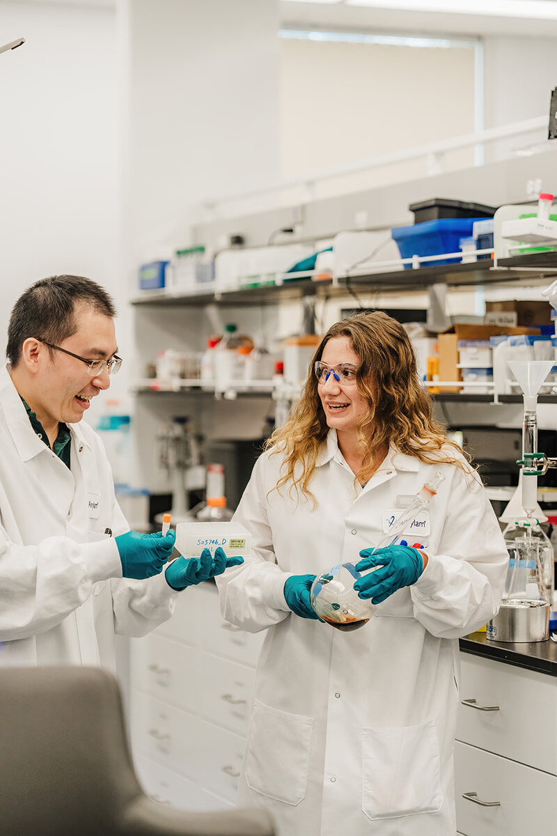scientists laugh together in a lab during photoshoot in boston