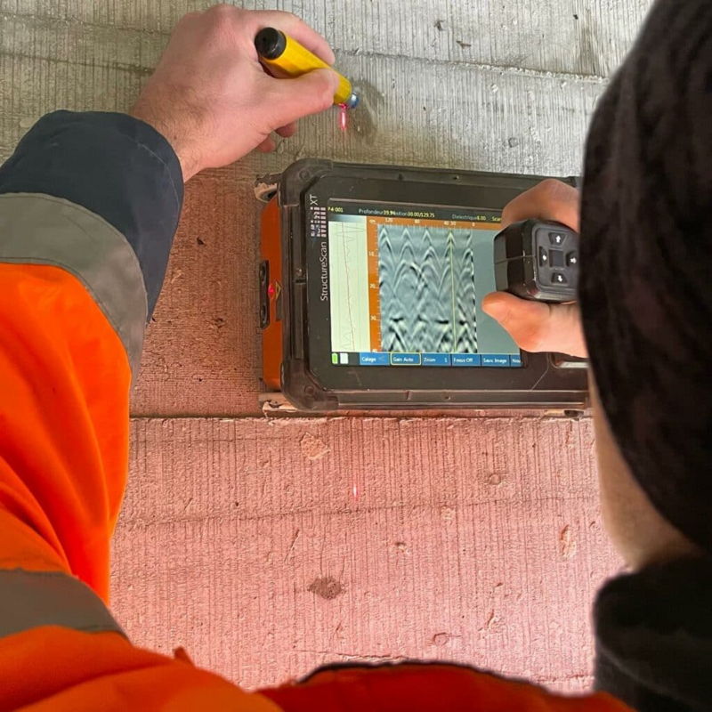 An operator using a top of the line GSSI ground penetrating radar equipment  to locate all hidden obstructions in concrete.