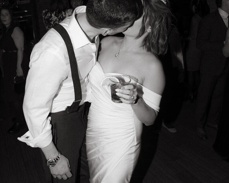 Bride and groom kissing on the dance floor at their wedding