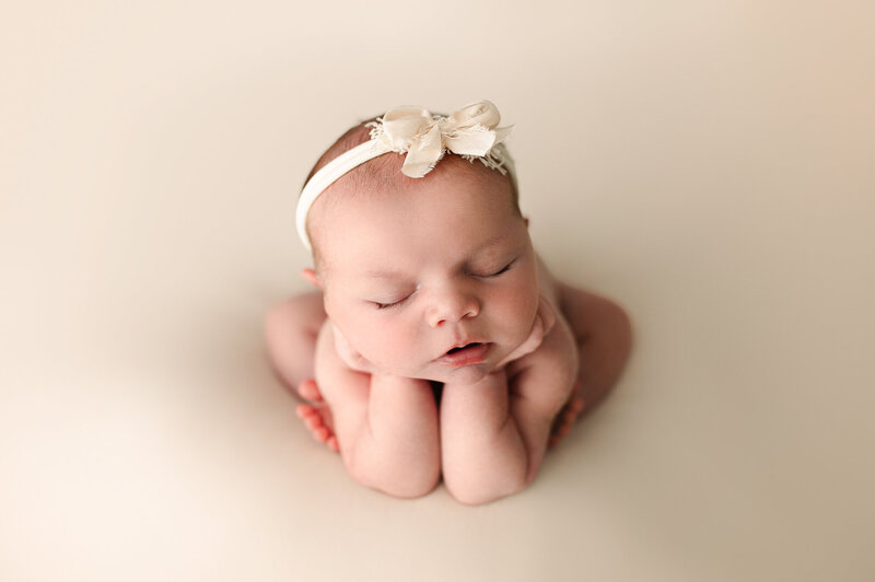 Studio session natural baby with hands under chin newborn near Toledo Ohio