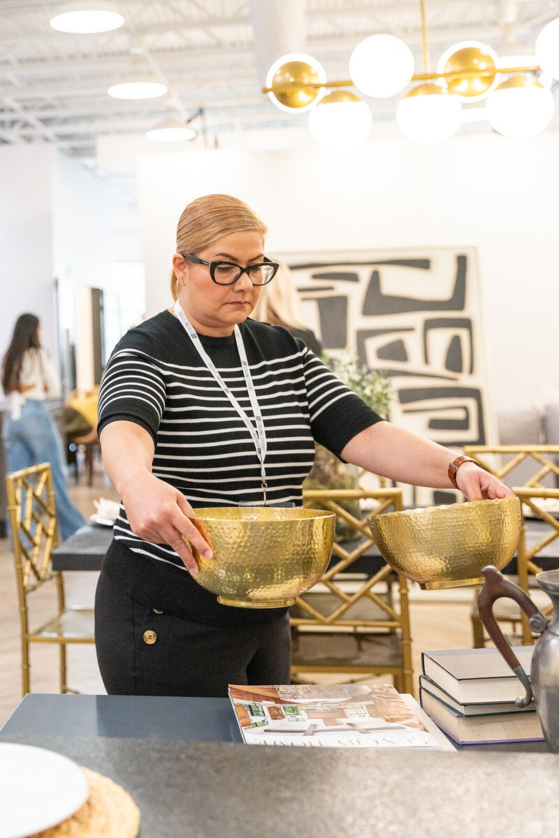 Owner comparing 2 gold bowls