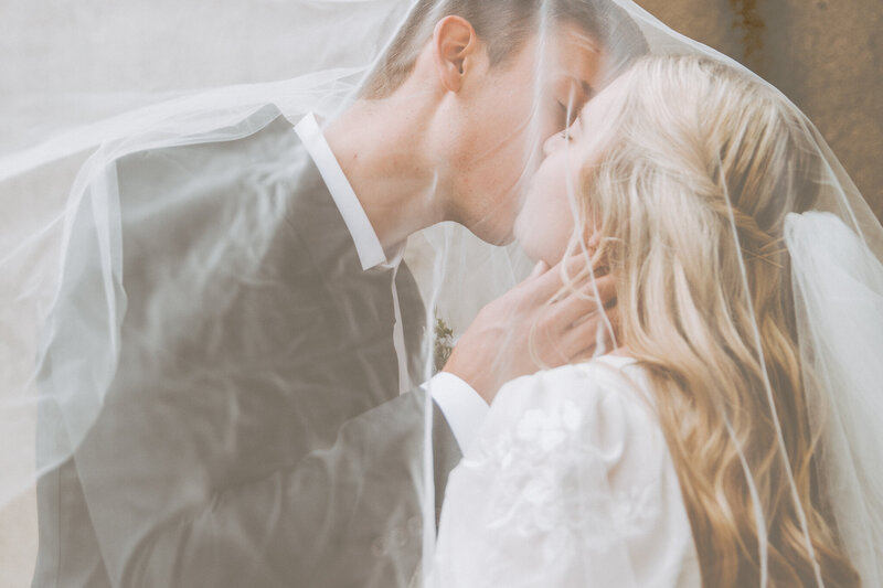 Photograph of couple embracing  at Folly Beach outside of Charleston