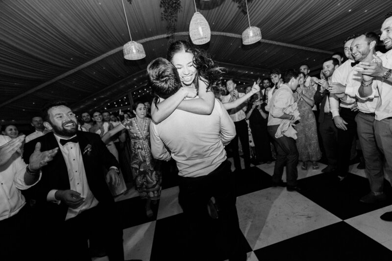 Bride jumps into groom's arms on dance floor at Glen Foerd Estate in Philadelphia, PA