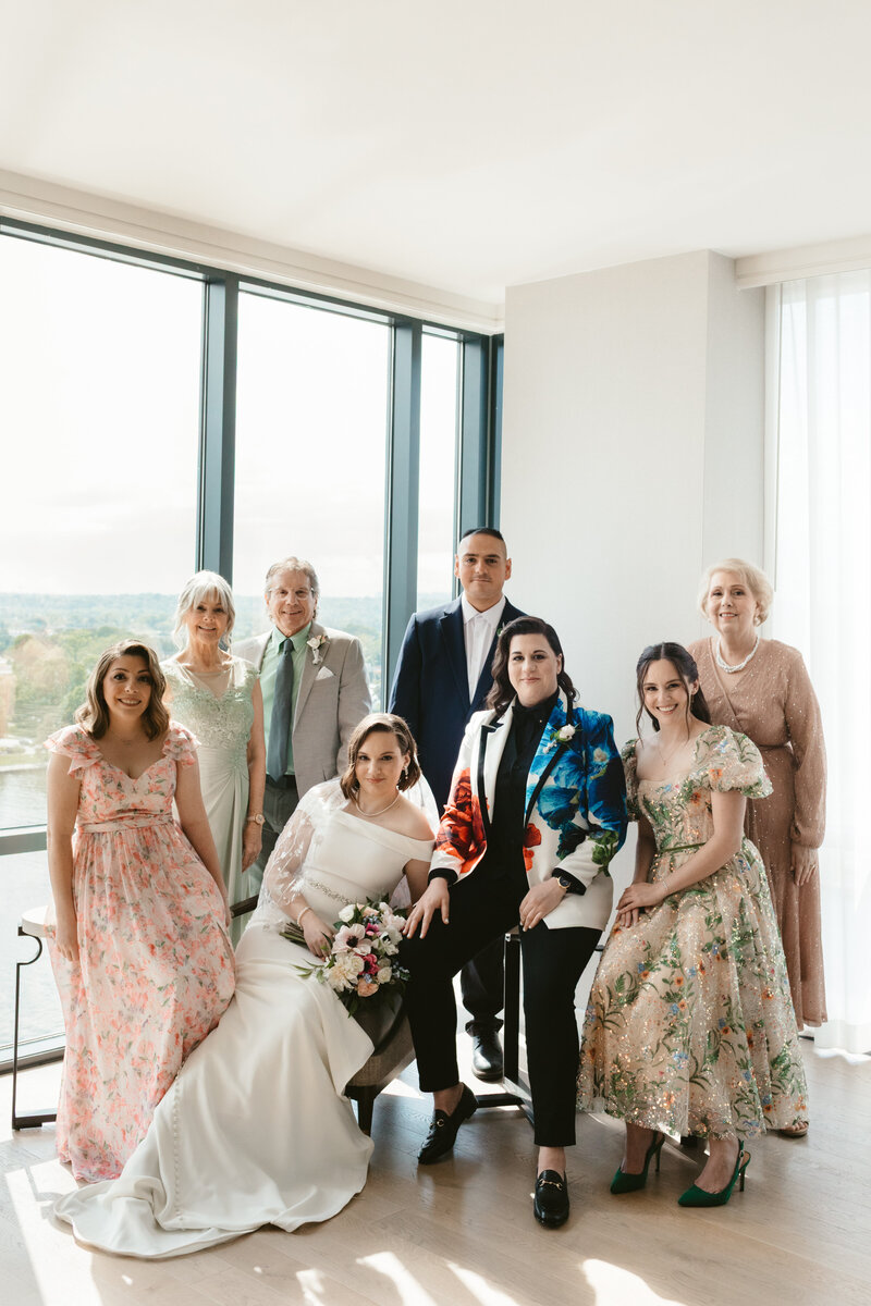 family formal portrait of combined family members of a Palestinian fusion mico lesbian wedding 