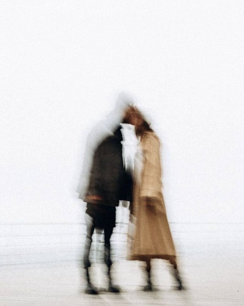 blurry image of a man and woman kissing