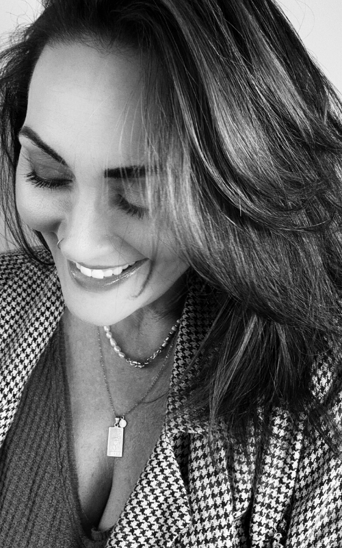 smiling woman with long hair wearing necklaces looking off to the side pro senior photographer