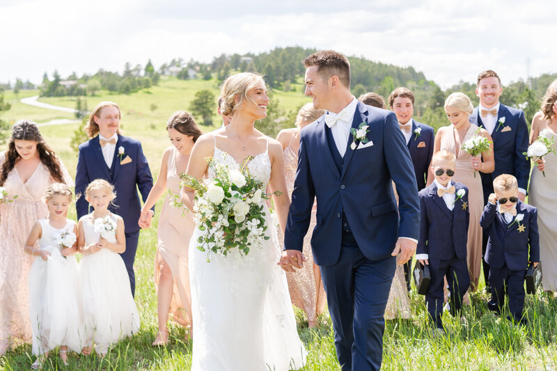 Bridal party walking with bride and groom