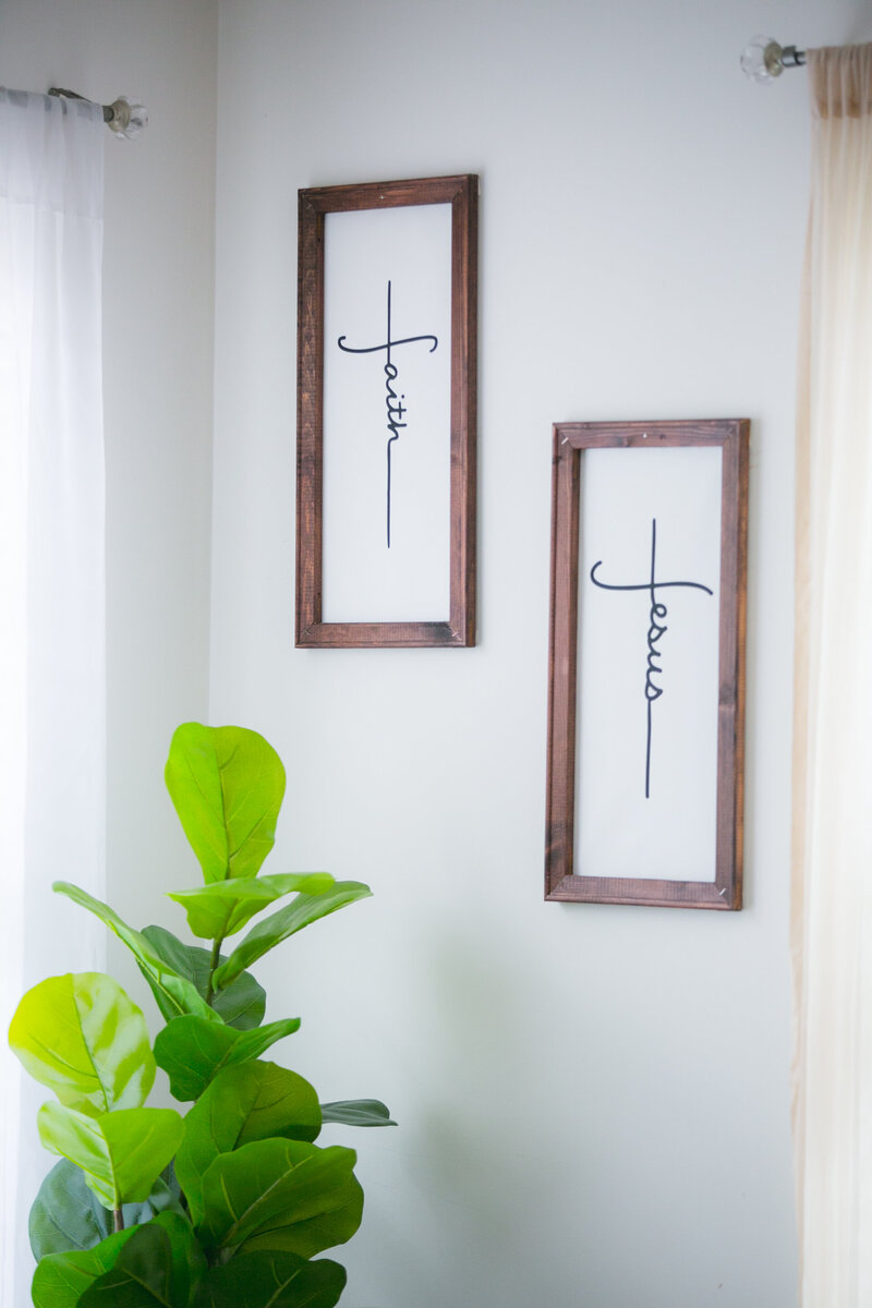 Two vertical wooden-framed canvas wall signs reading “Faith” and “Jesus” in modern calligraphy, handmade Christian wall art by Cobero Collective.