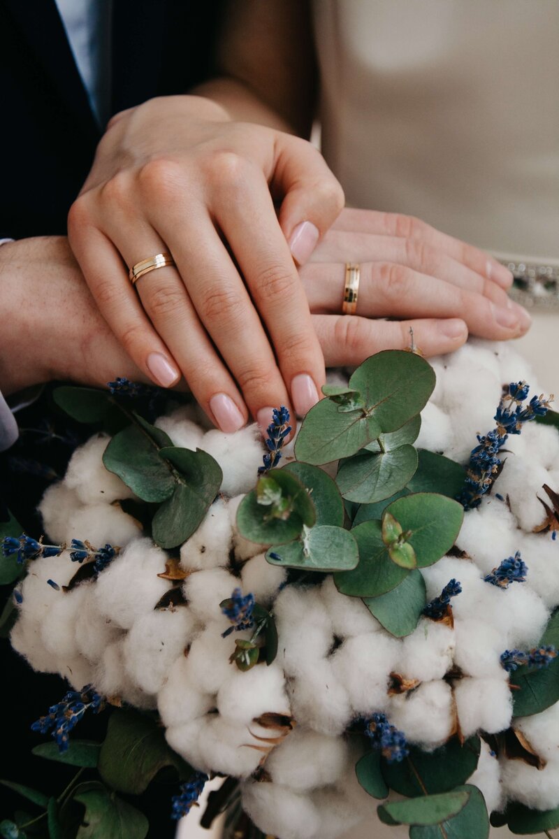 couple getting married, rings and bouquet