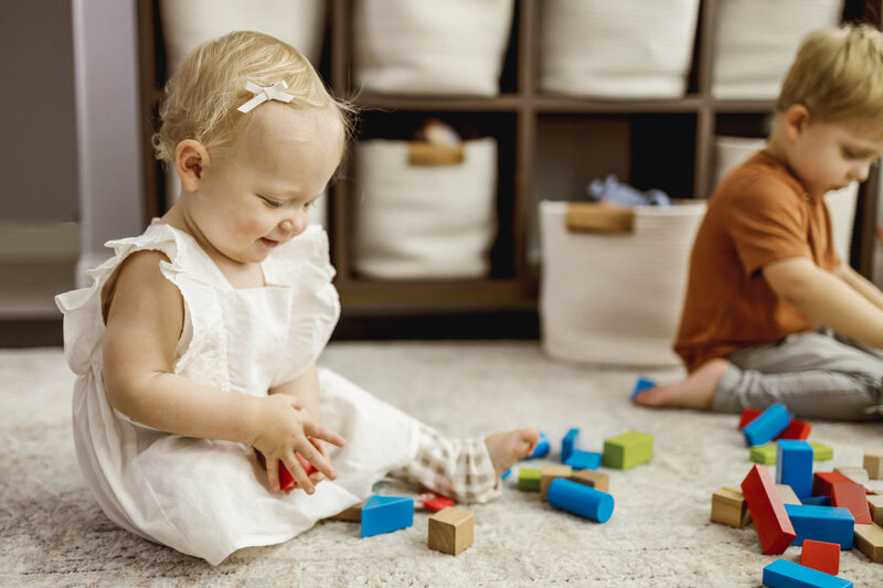 a toddler girl plays with the blocks in a home in carrollton texas