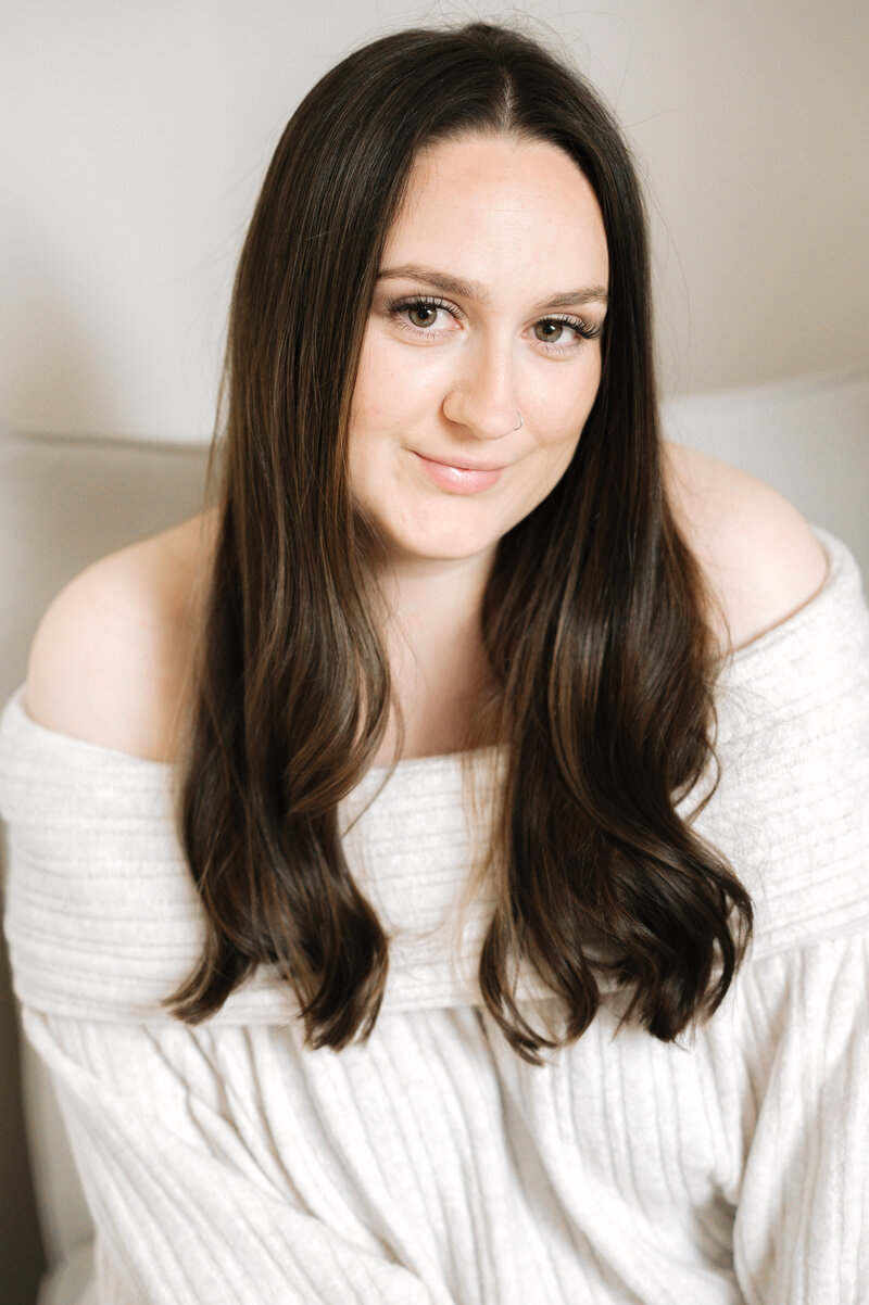 A girl smiling sitting down at a photoshoot in Billingshurst