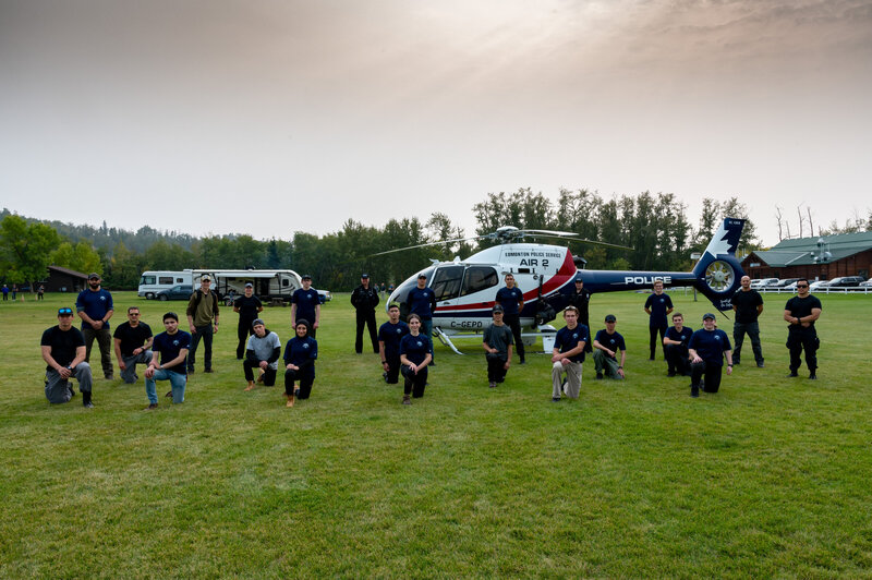 Participants in a custom leadership program engaging in a field-based team-building session with hands-on exercises