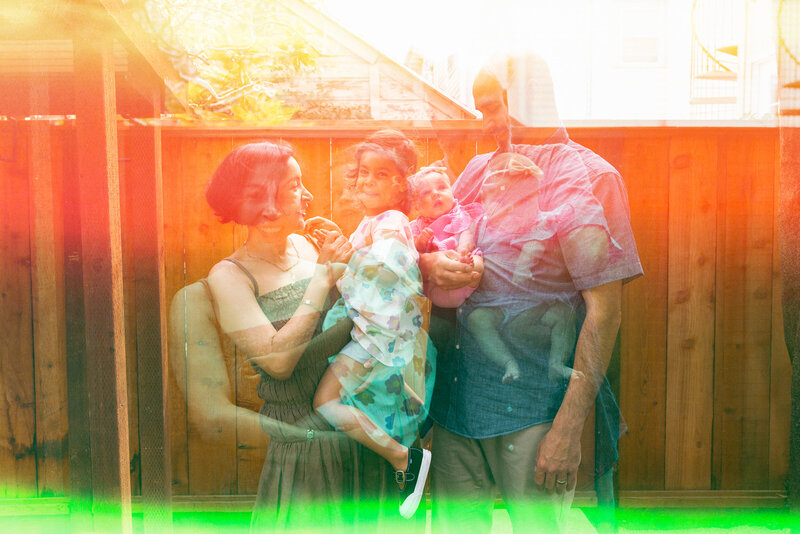 double exposure of family of four standing in their backyard