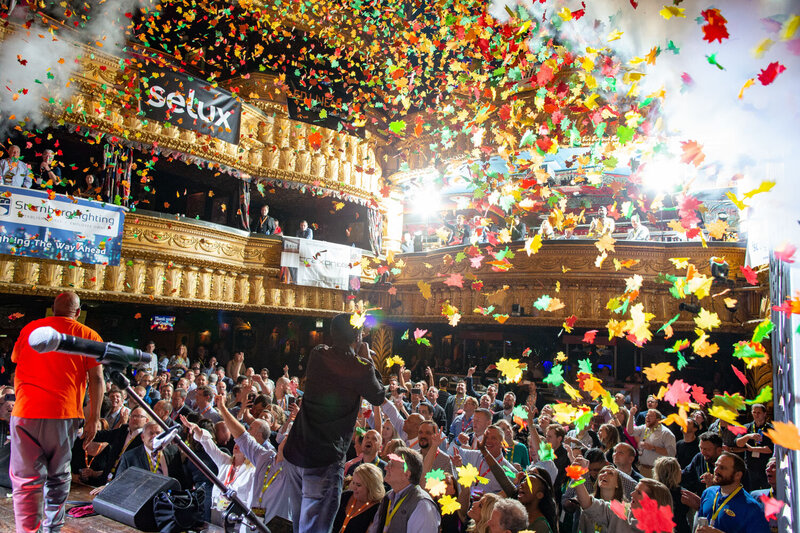 Performer on stage as colorful confetti rains over the crowd