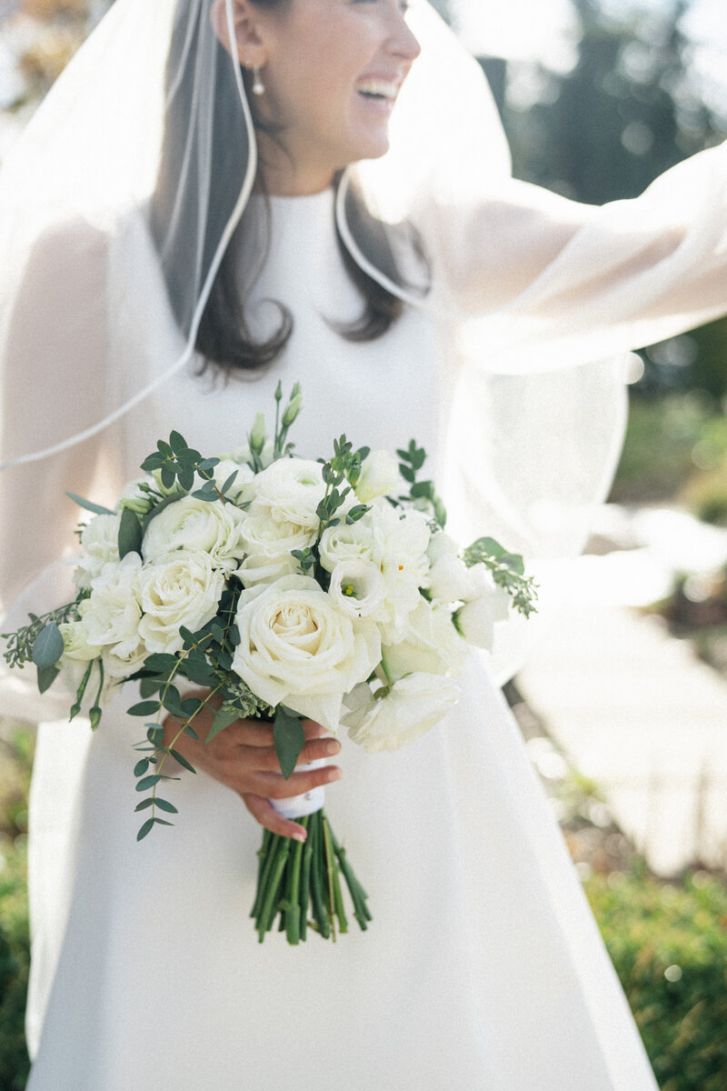 Bride holding white rose bouquet at her late fall intimate wedding in Cleveland, Ohio.


