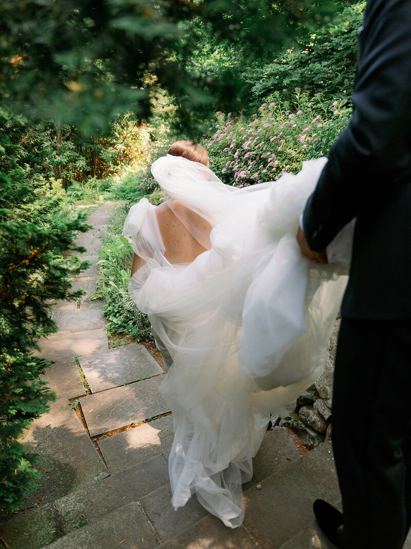 Bridesmaids in mismatched colorful gowns with monochrome flowers for a destination wedding in the mountains at Cedar Lakes Estate