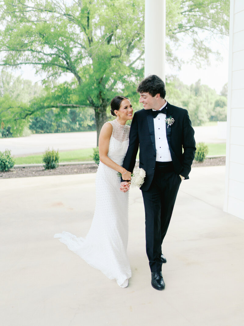 Bride and Groom in White Tuxedo and Maggie Louise Wedding Dress