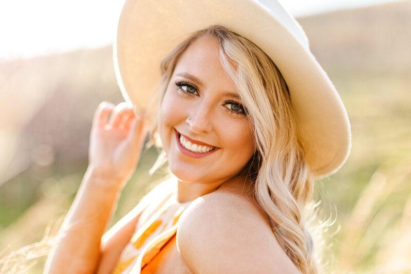close up of a girl wearing a sun hat