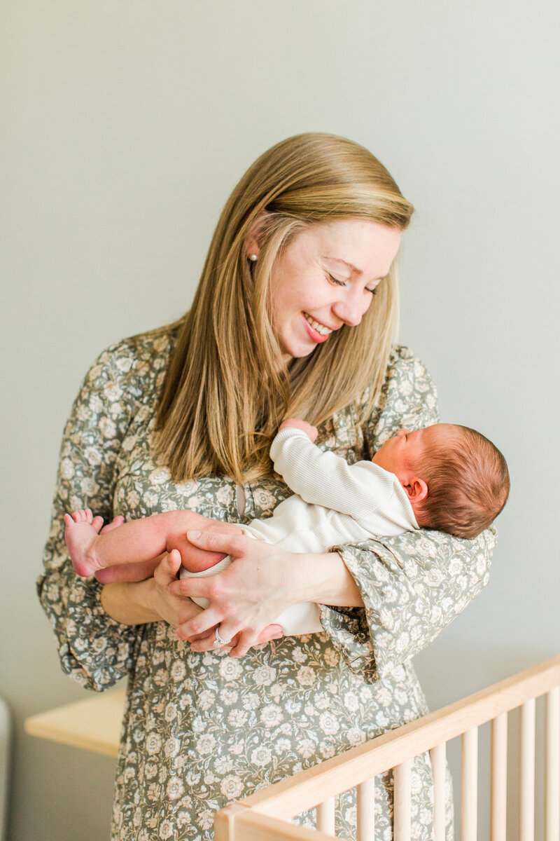 mom holds newborn baby in her arms