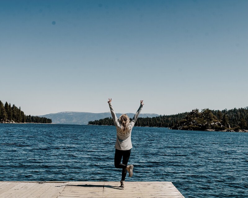 woman standing on a dock in lake tahoe