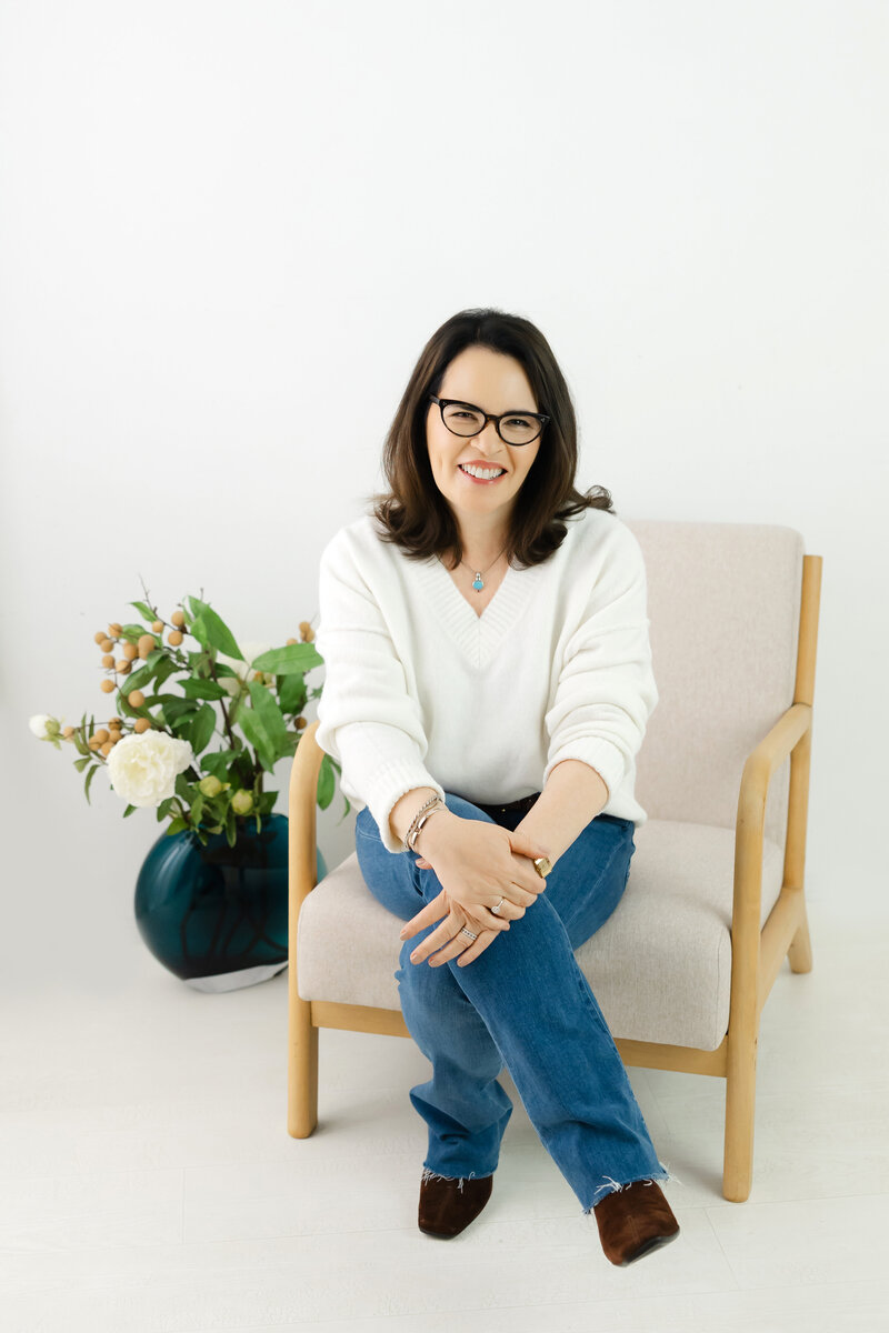 Coach smiling in cozy modern setting representing calm confidence and authenticity