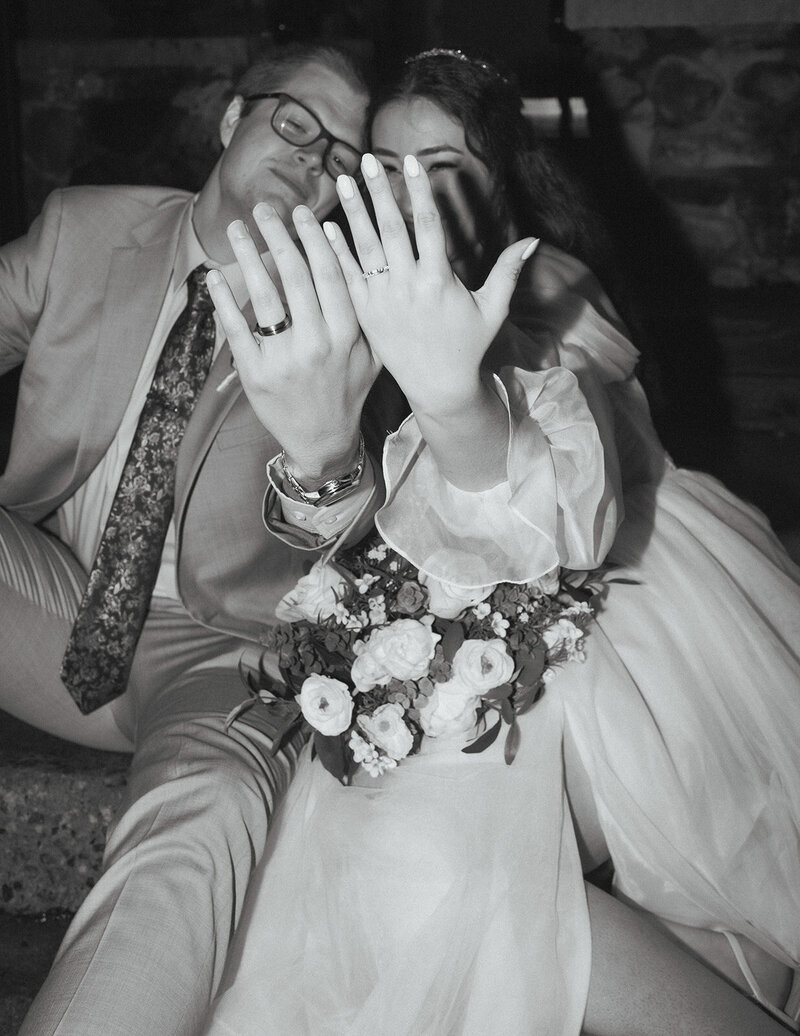 Black and white photo of Cerise and Geoff enjoying wedding cake together