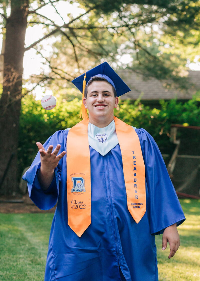 Posed photo of a graduate wearing a graduation cap and gown.