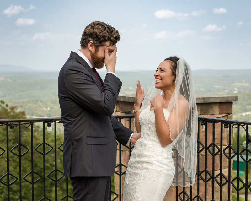 Groom covers his eyes to wipe away tears during a heartfelt first look at Blue Mountain overlooking Lehigh Valley.