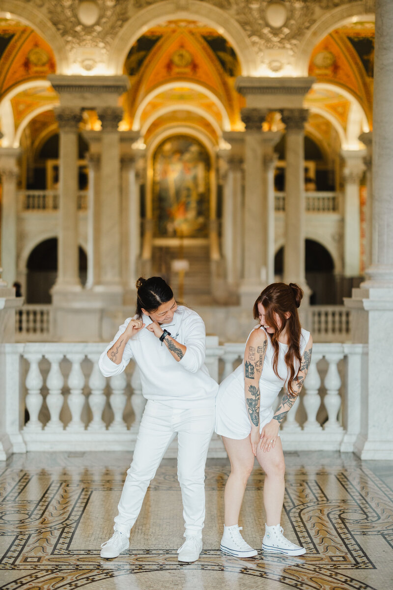 Two people dancing together and bumping hips 