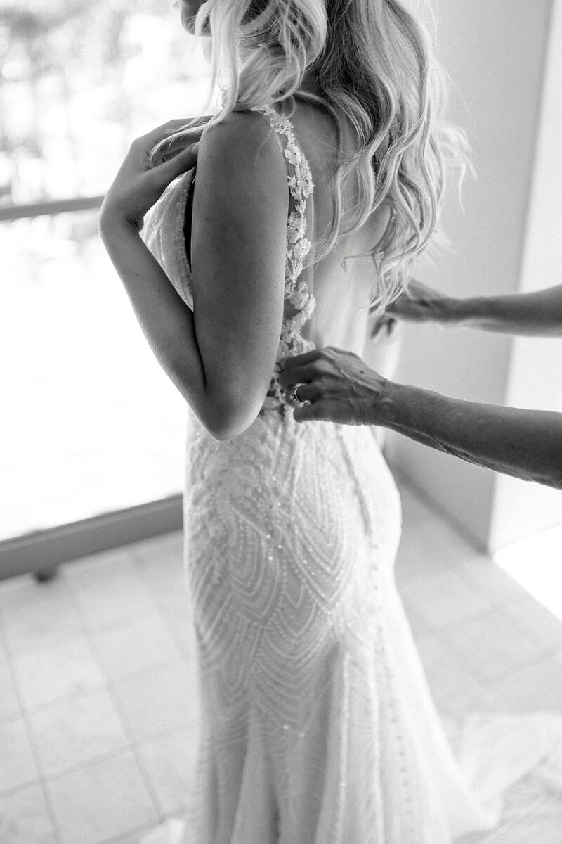 Tiffany Longeway Photography captures the intricate details of bridal preparations at the luxurious Langham, Huntington in Pasadena. This close-up black and white image highlights the delicate beading of the bride’s gown and the tender moments leading up to the ceremony, making it ideal for couples seeking an elegant and sophisticated wedding experience in a historic and prestigious venue.