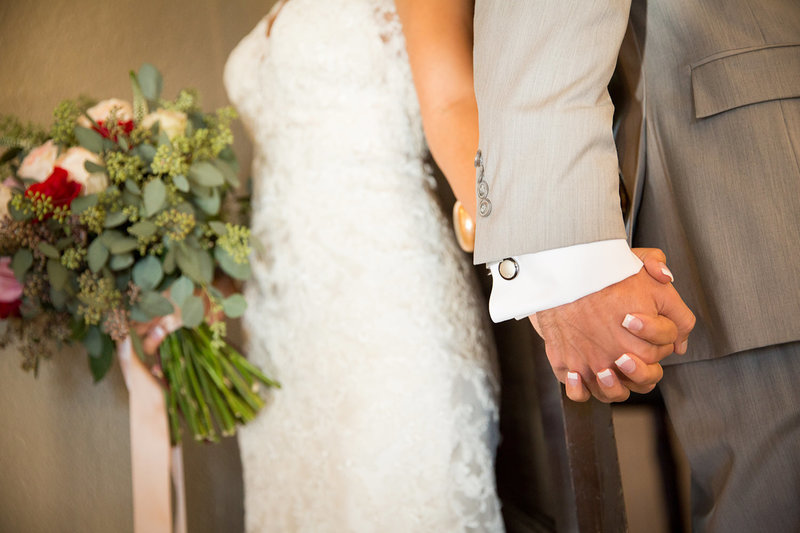 bride and groom holding hands