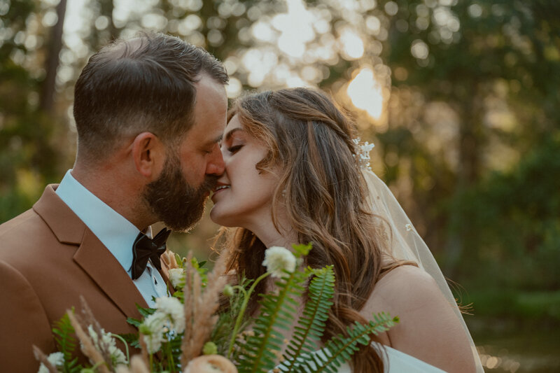 bride and groom kissing at cathedral beach picnic area yosemite