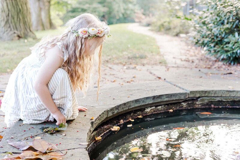 Photograph of girl looking into a pond in a Lower Merion  garden