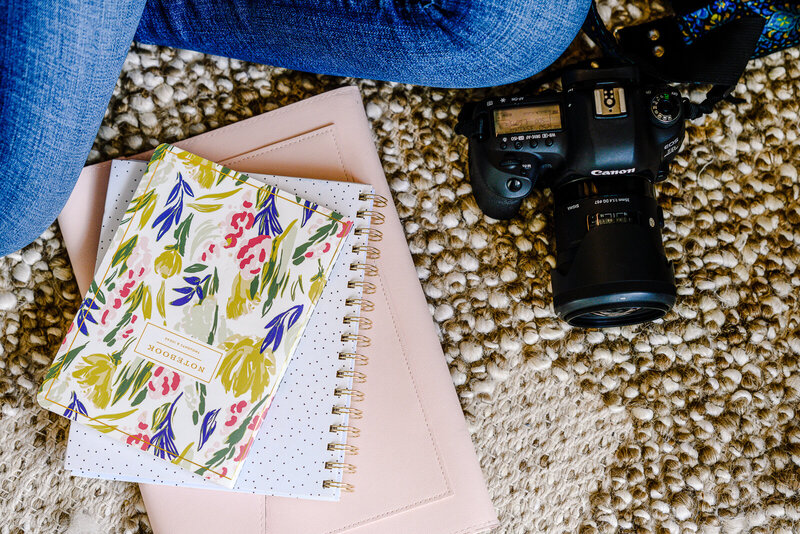 detail shot of camera, journals and other details on the floor for brand photography with Orlando photographer