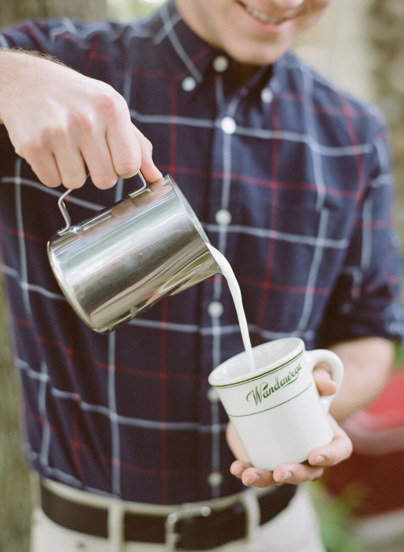 man pouring latte at small business retreat by brand photographer studio soma in madison wisconsin