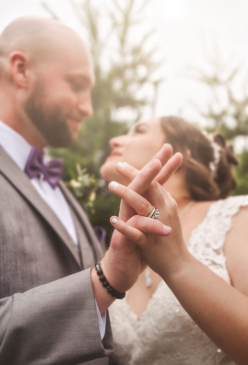 Bride standing gracefully in front of a large window, bathed in soft natural light, wearing an elegant wedding gown—capturing a moment of timeless elegance and refined beauty.