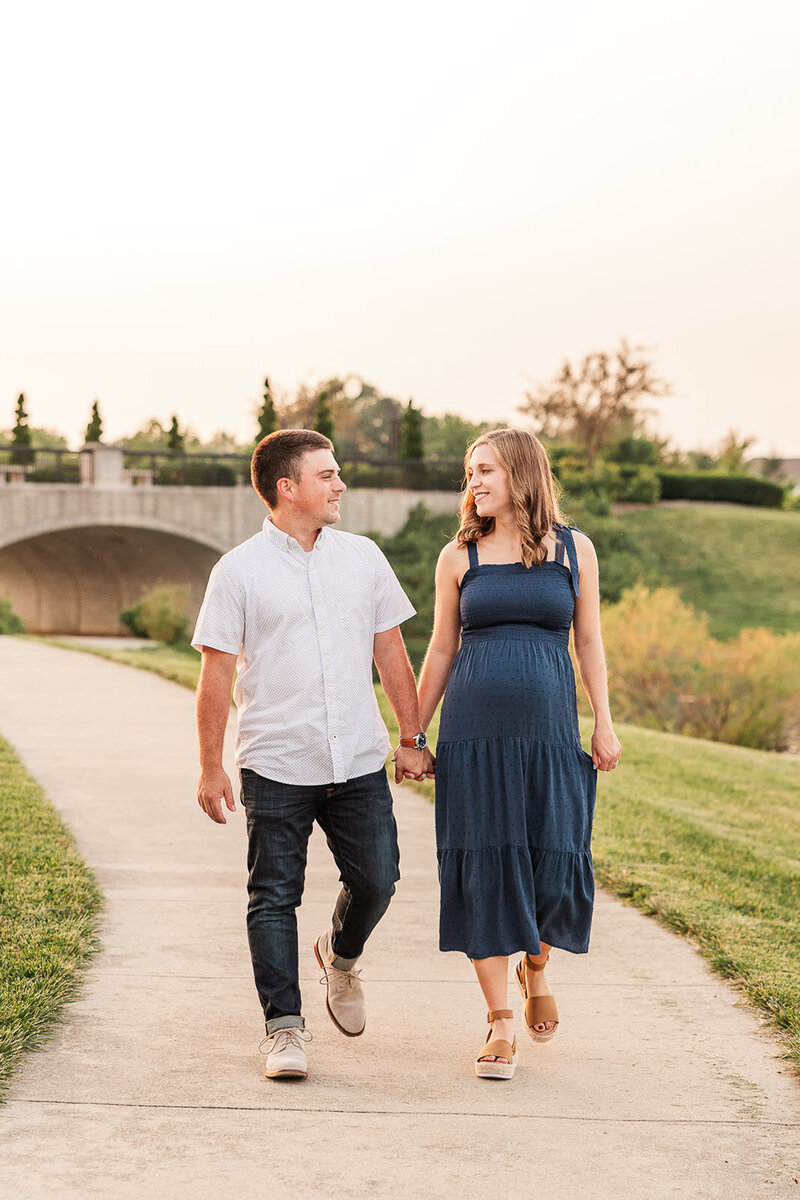 Pregnant couple walking in a park