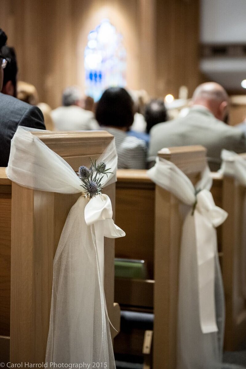 Wedding aisle decor of white chiffon and blue flowers