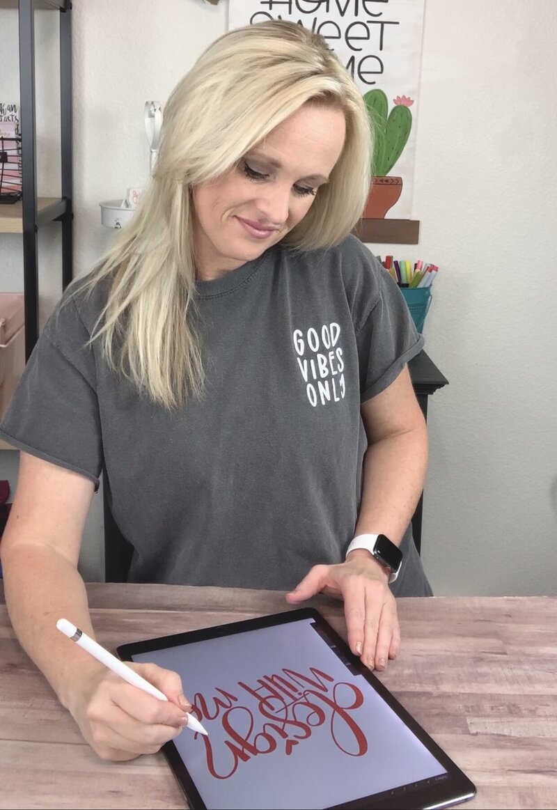 Blonde woman designing on iPad using Procreate