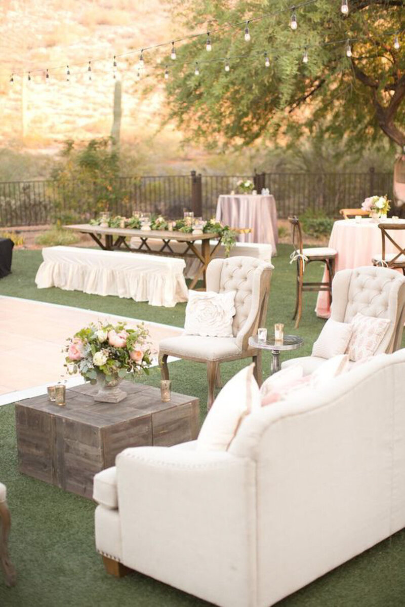 Elegant white sofas and table for outside wedding reception