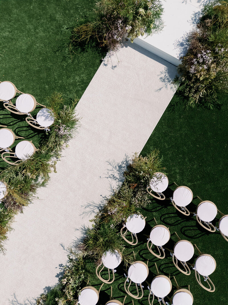 Drone shot of ceremony with runner and platform at Wildflower Farms