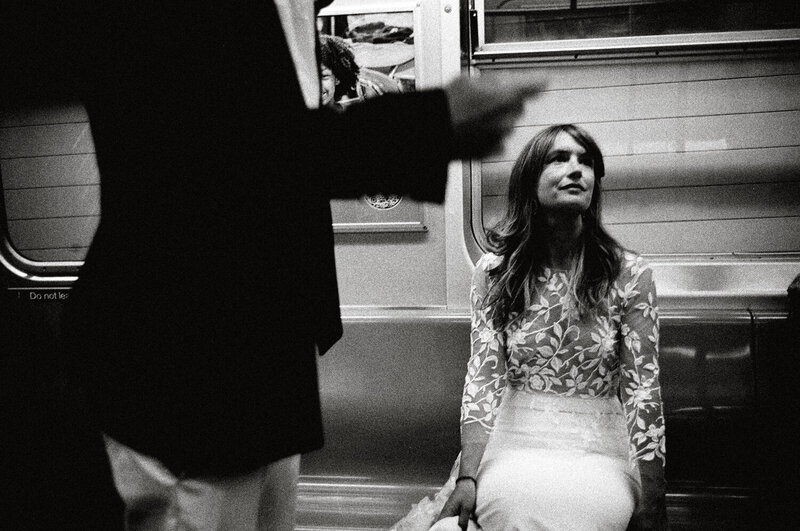 Bride and groom riding the subway in NYC.