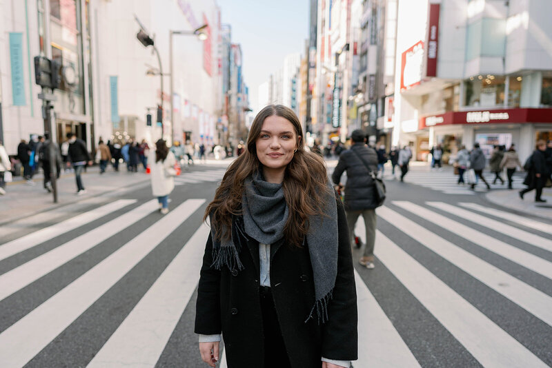 Portrait of Raechel Marie Photo standing in the middle of Shibuya Crossing in Tokyo, Japan during her travels
