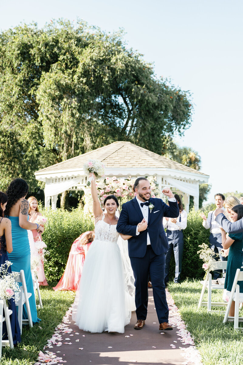 Palm Beach Wedding Photographer captures couple walking down aisle together