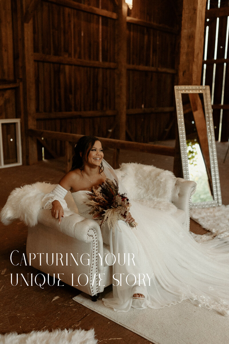 Bride sitting on a white couch with train flowing on the ground and bouquet in her lap.